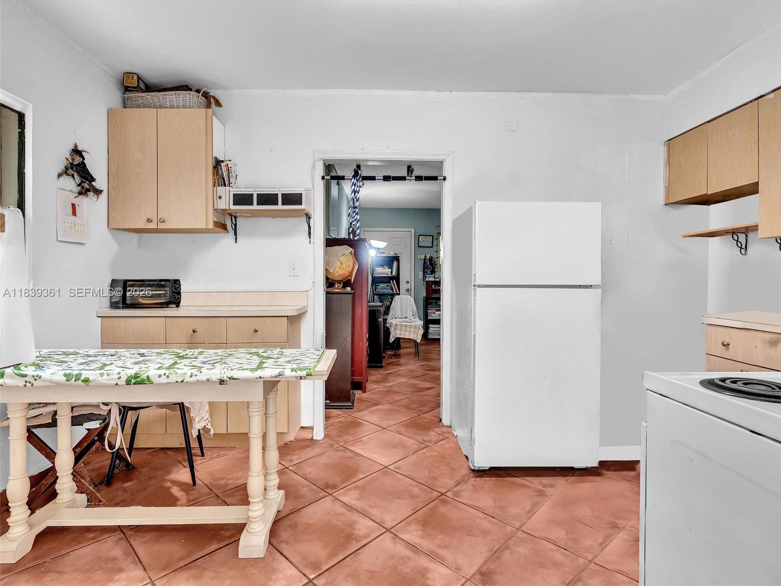 3210 Elizabeth Street Miami, FL 33133 - Photo 54 of 69 a kitchen with stainless steel appliances granite countertop a refrigerator sink stove and white cabinets