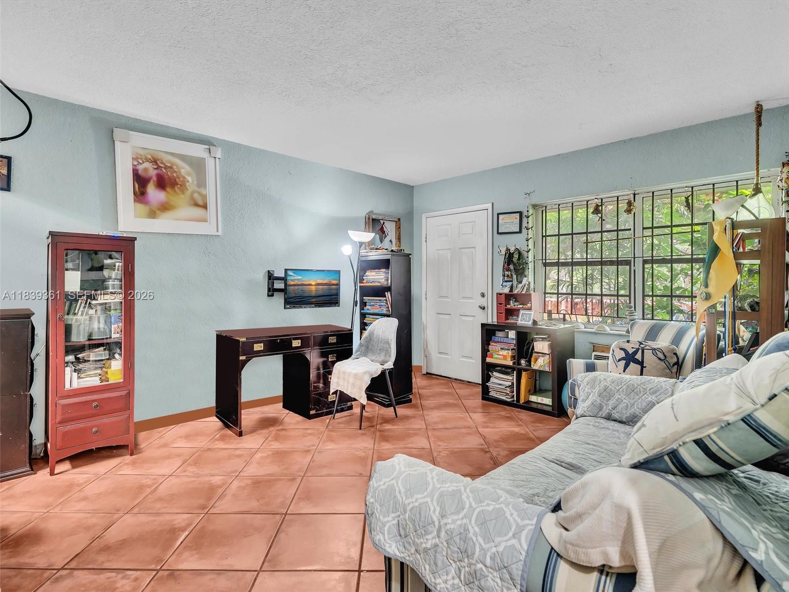 3210 Elizabeth Street Miami, FL 33133 - Photo 60 of 69 a living room with furniture and a flat screen tv