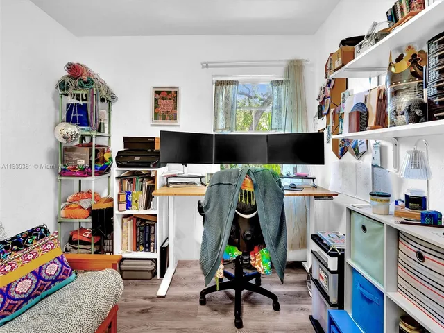 a bedroom with a bed and a bookshelf with wooden floor