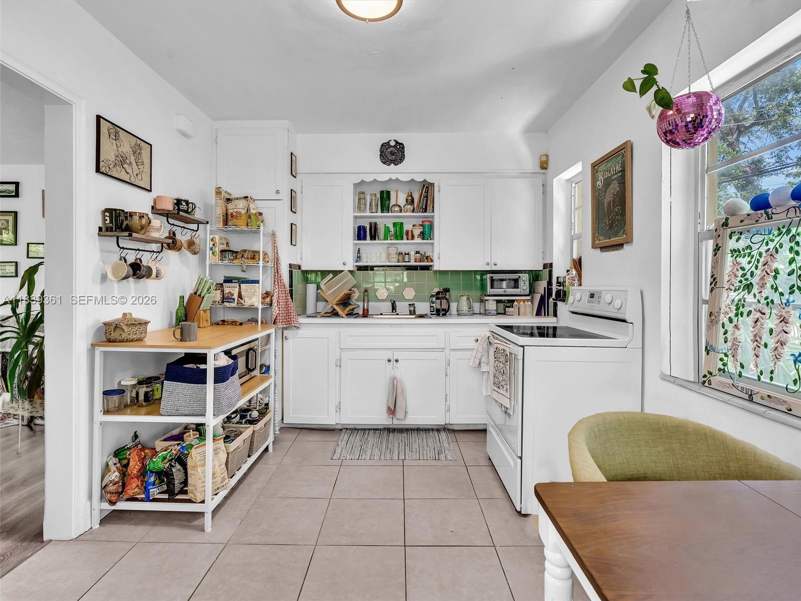 3210 Elizabeth Street Miami, FL 33133 - Photo 10 of 69 a kitchen with a refrigerator and sink