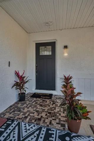 a view of a kitchen with a refrigerator and a window