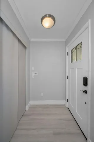 a view of a kitchen with a sink and dishwasher a refrigerator with wooden floor