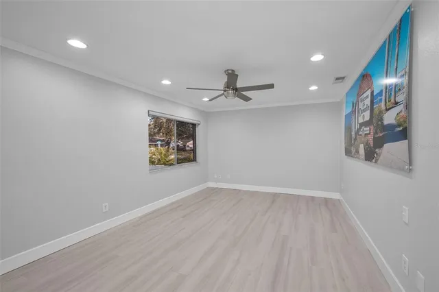 a kitchen with stainless steel appliances kitchen island granite countertop a stove a sink dishwasher and a microwave with wooden floor