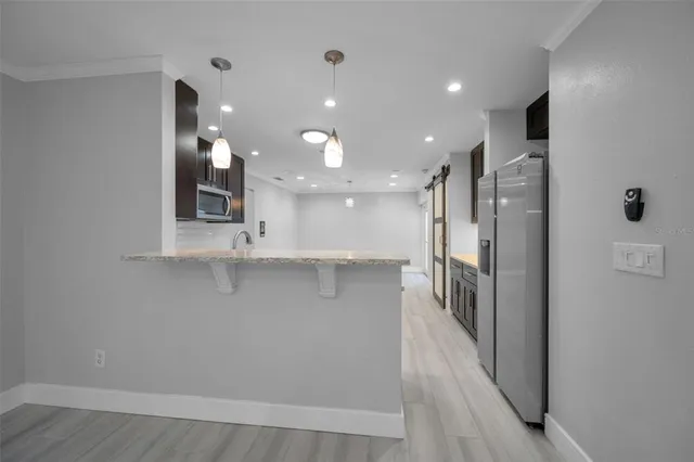 a view of a kitchen with a sink and wooden floor