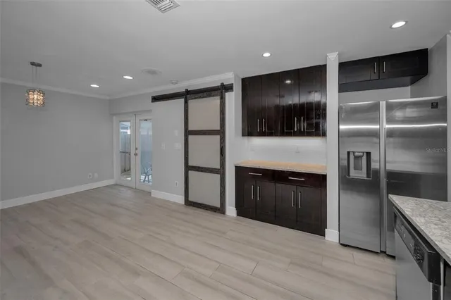 a view of an empty room with wooden floor