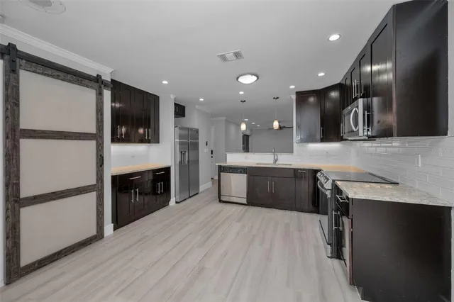 a bathroom with a granite countertop sink a mirror and a shower