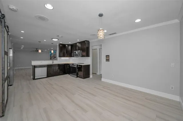 a view of a patio with table and chairs and potted plants