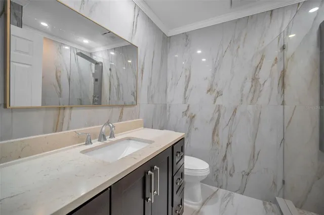 a view of a sign board with buildings in the background