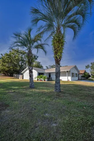 a view of backyard with swimming pool and outdoor seating