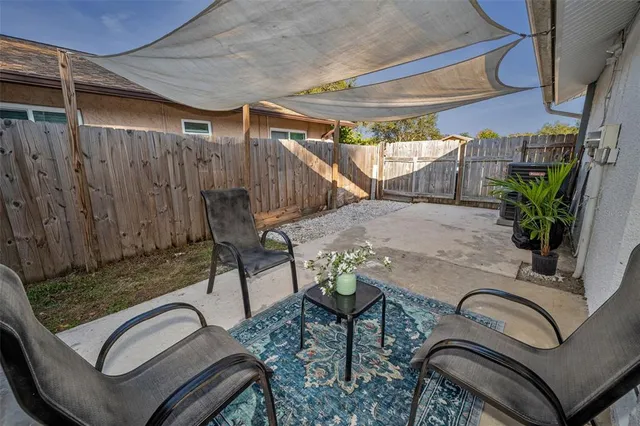 a sign that is sitting in front of a tree