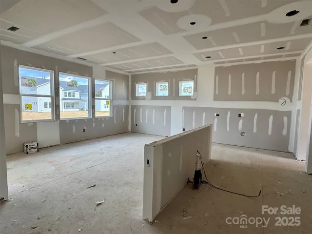 a view of an empty room with large windows