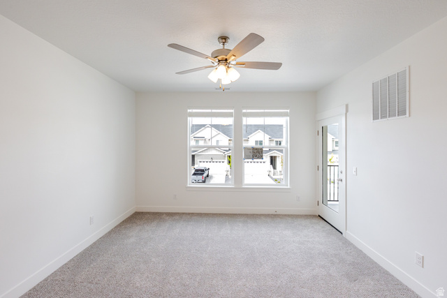 675 West 4500th South, Unit P201 Mapleton, UT 84664 - Photo 15 of 16 Spacious room featuring neutral carpet, white walls, and a ceiling fan with integrated lighting
