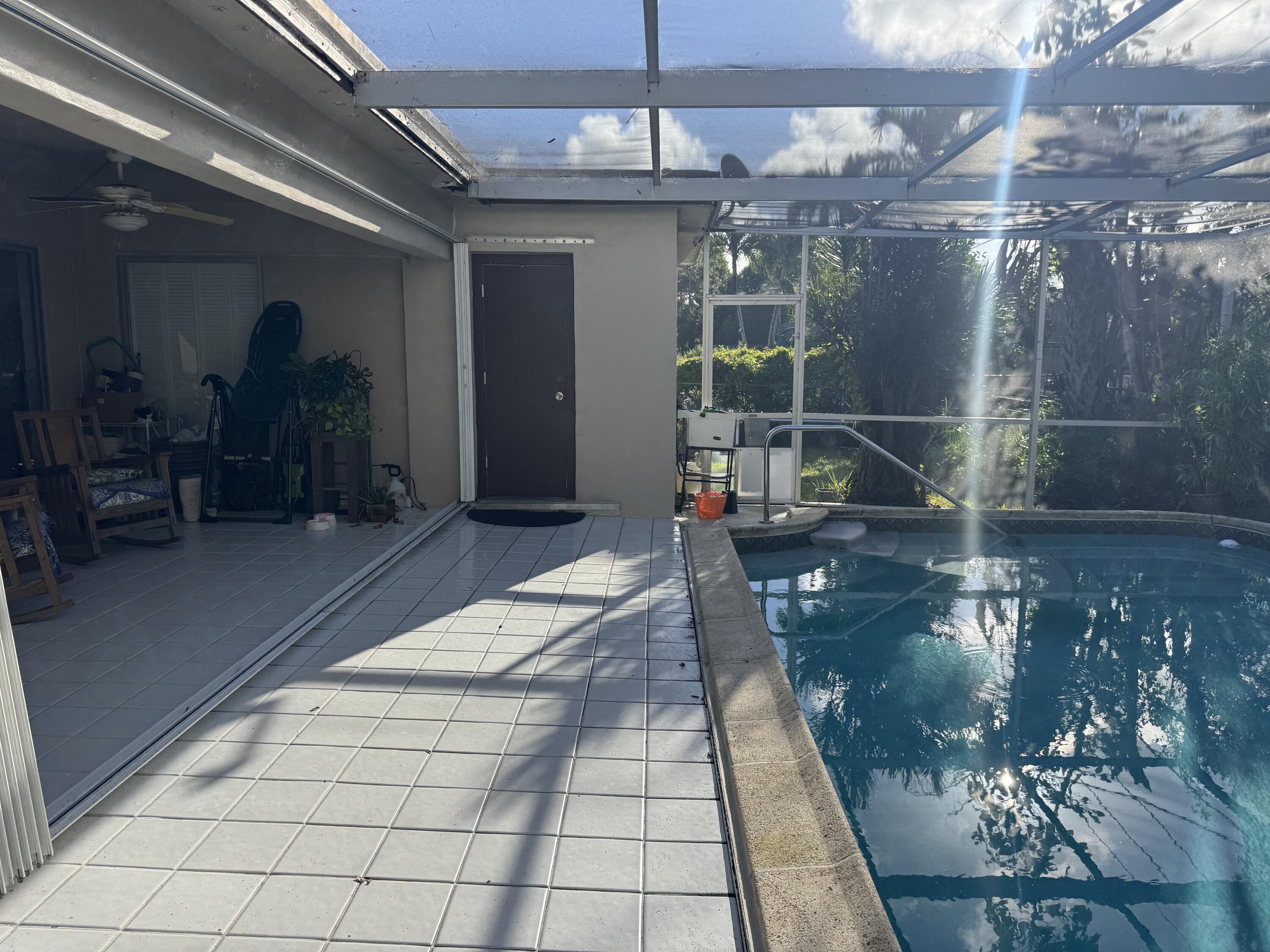 8970 Southwest 53rd Street Cooper City, FL 33328 - Photo 16 of 17 a lobby with patio entrance and outdoor seating