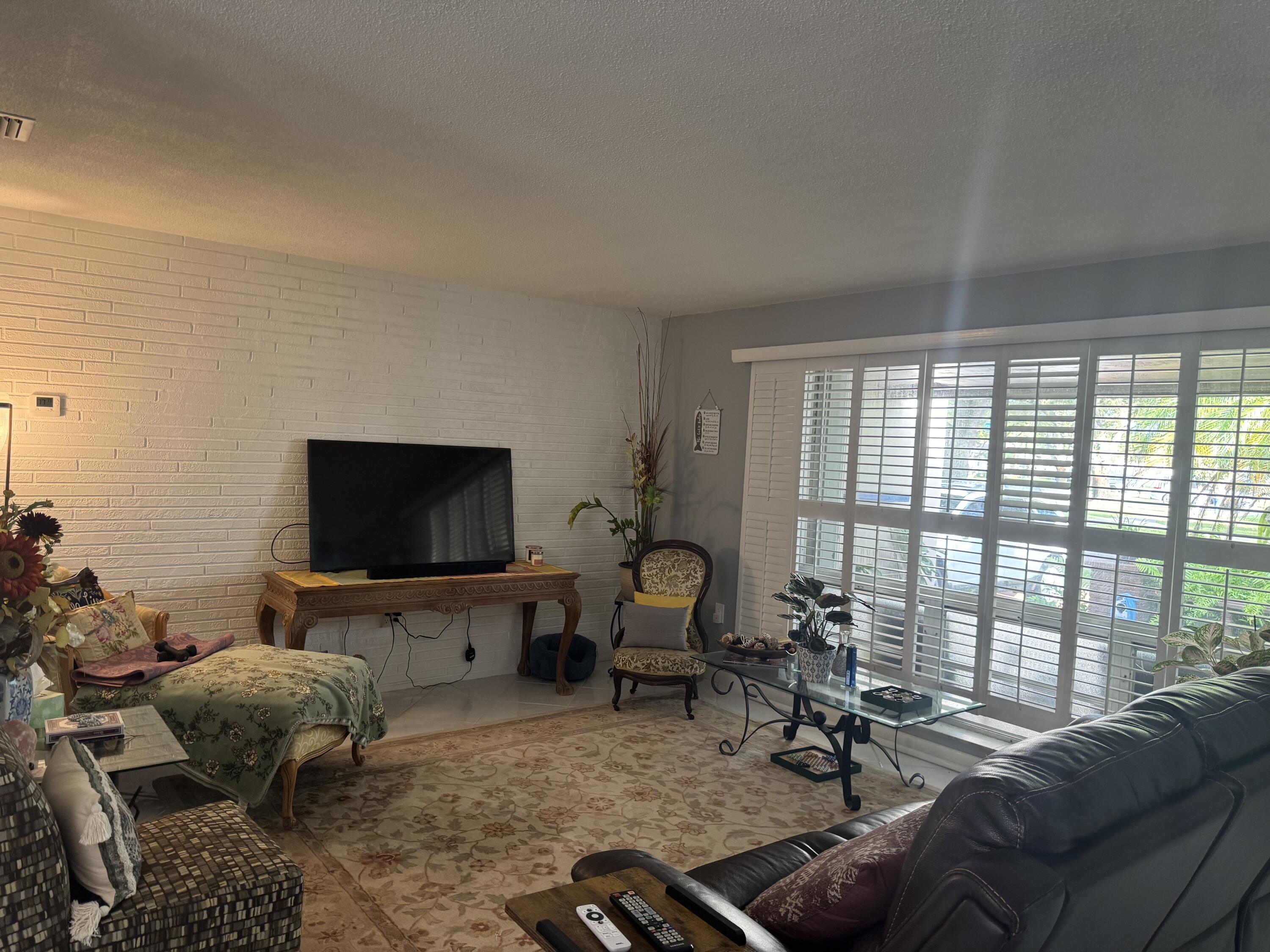 8970 Southwest 53rd Street Cooper City, FL 33328 - Photo 4 of 17 a living room with furniture and a flat screen tv
