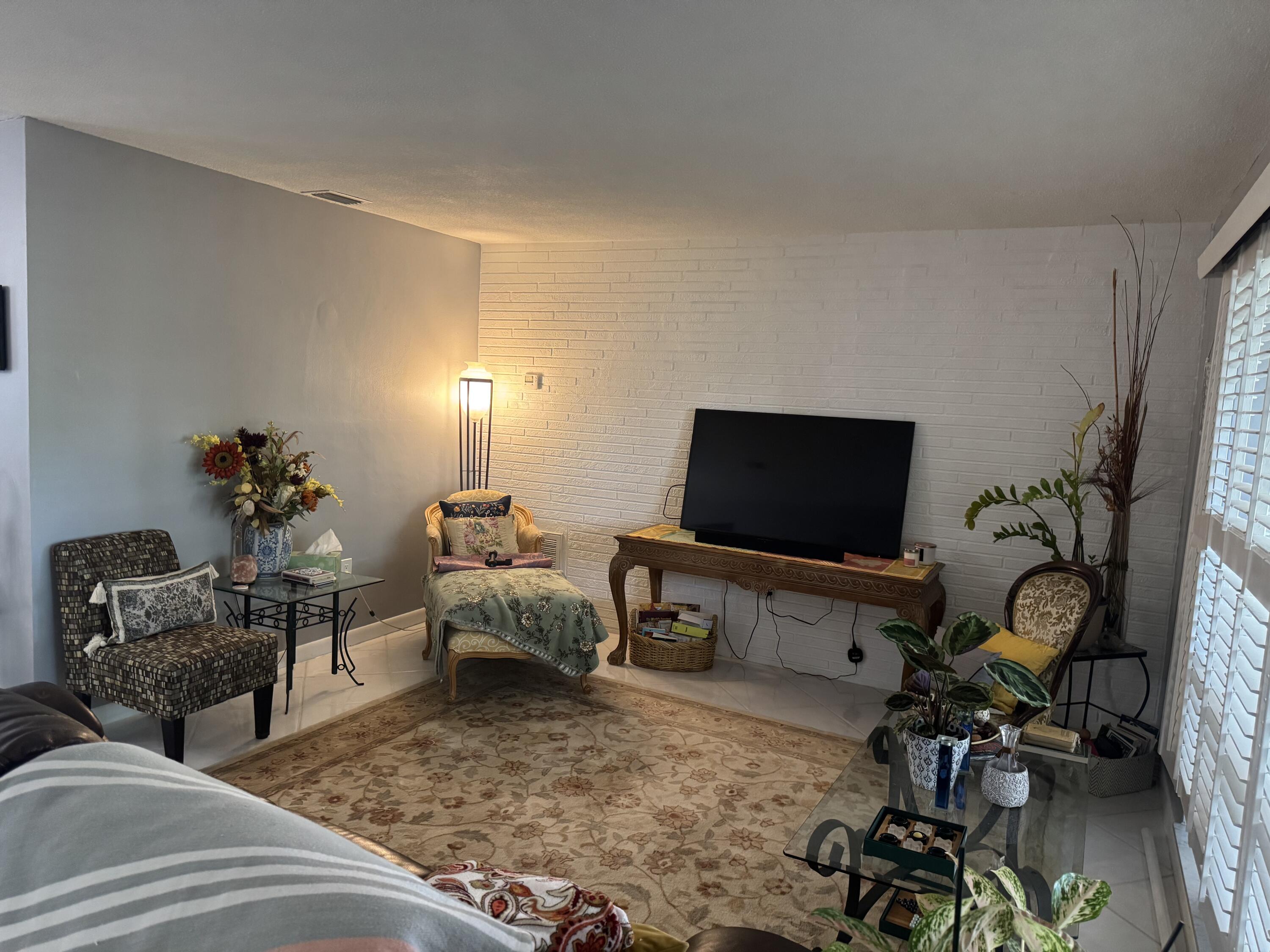 8970 Southwest 53rd Street Cooper City, FL 33328 - Photo 5 of 17 a living room with furniture and a flat screen tv