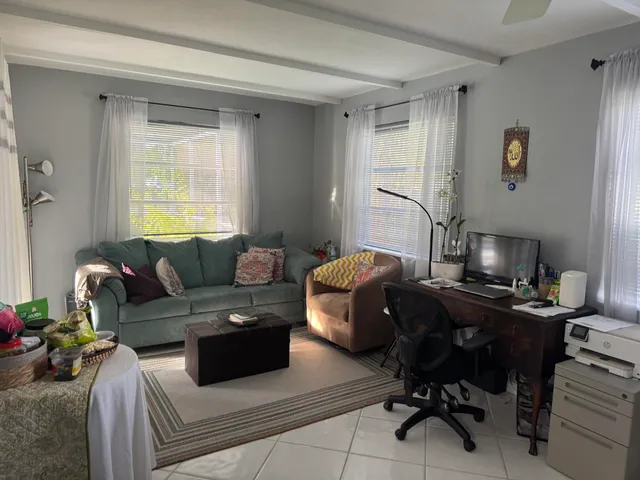 a living room with furniture rug and a window