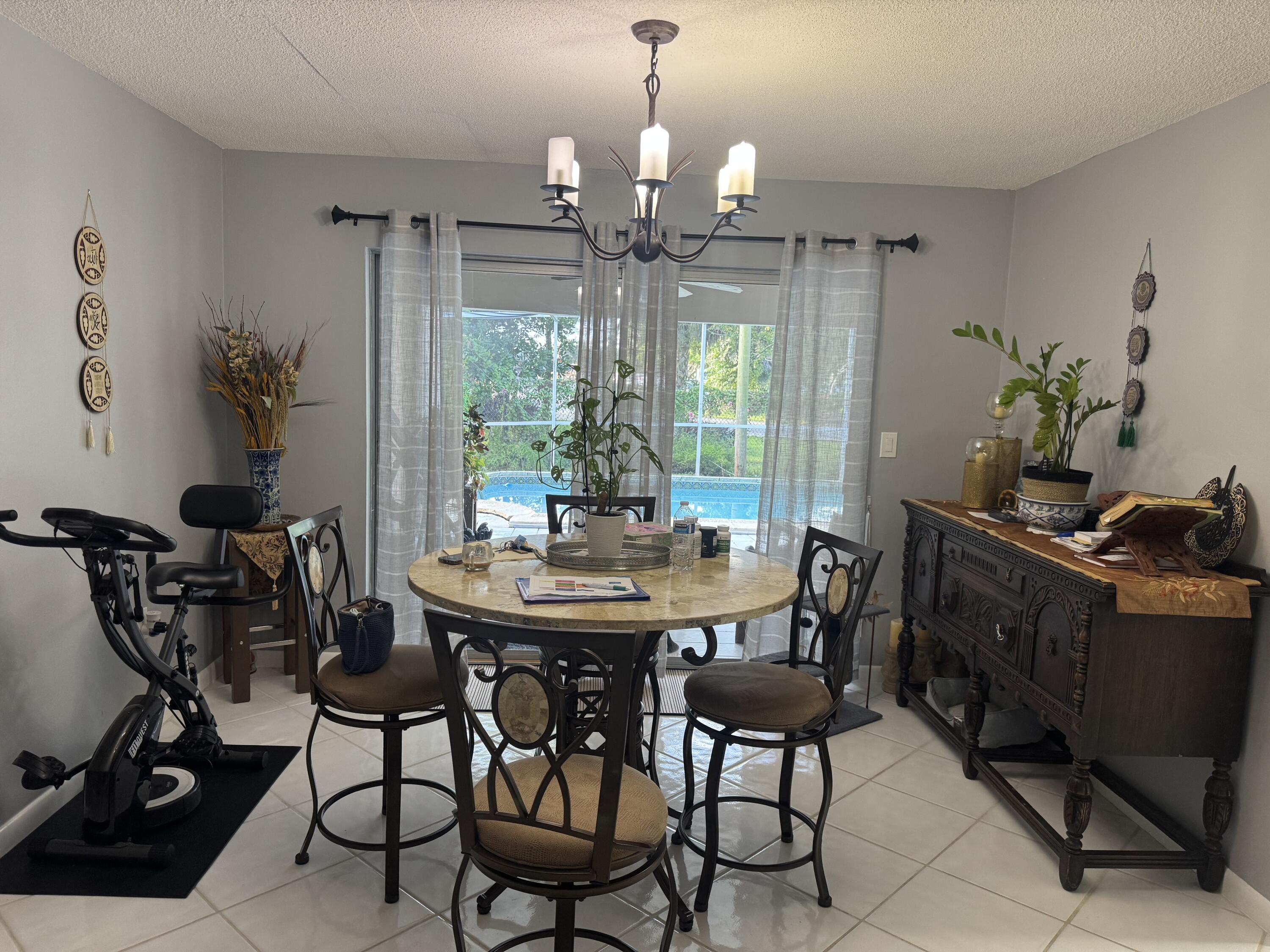 8970 Southwest 53rd Street Cooper City, FL 33328 - Photo 8 of 17 a view of a dining room with furniture and chandelier
