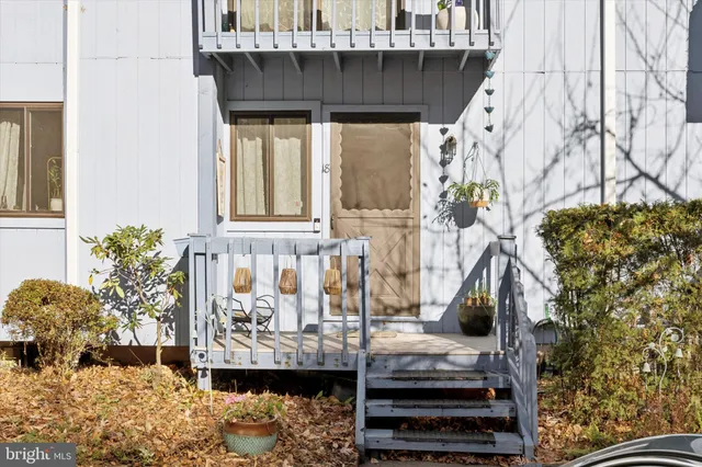 a view of balcony with furniture and potted plants