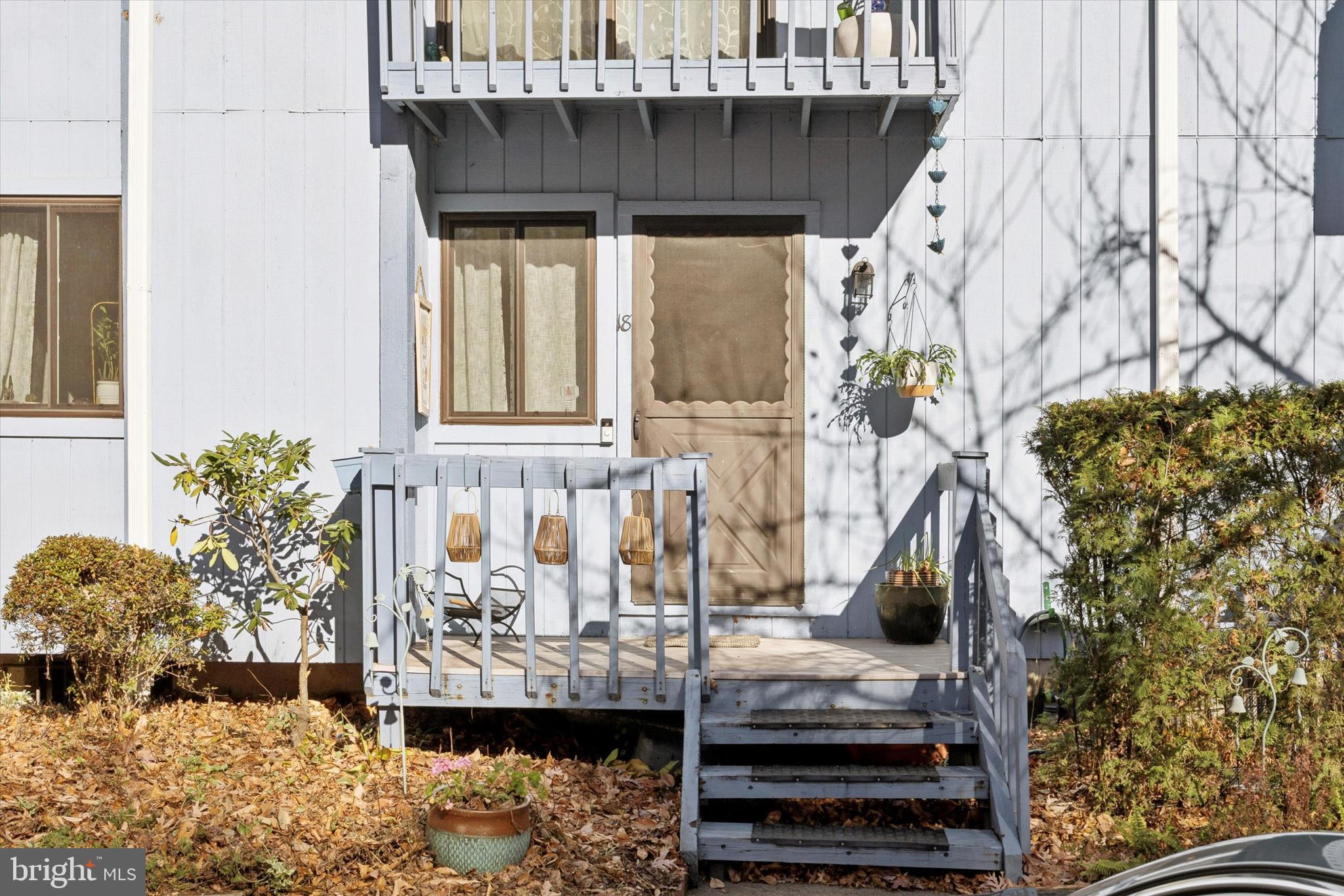 a view of balcony with furniture and potted plants