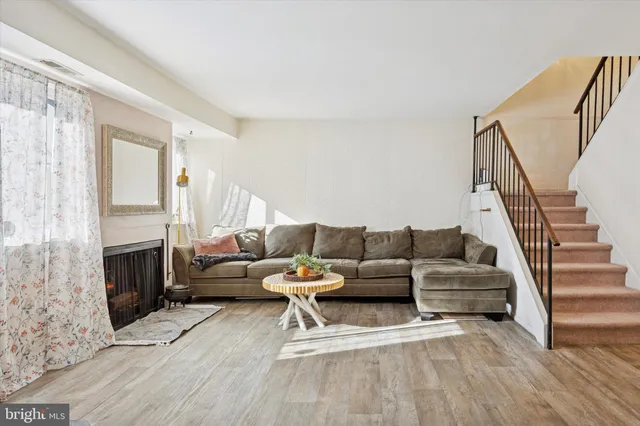a living room with fireplace furniture and a wooden floor