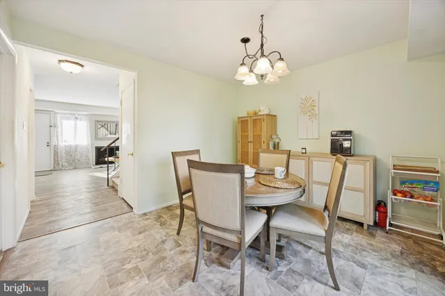 a view of a dining room with furniture and a chandelier