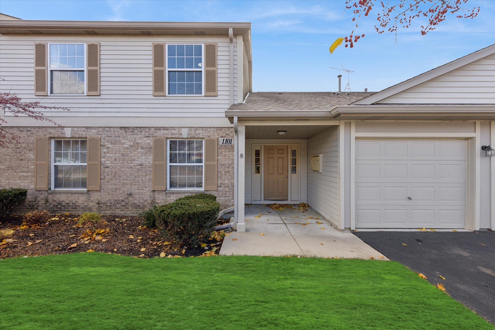 1101 Yorkshire Court, Unit C Elgin, IL 60120 - Photo 1 of 19 a front view of a house with a garden and plants
