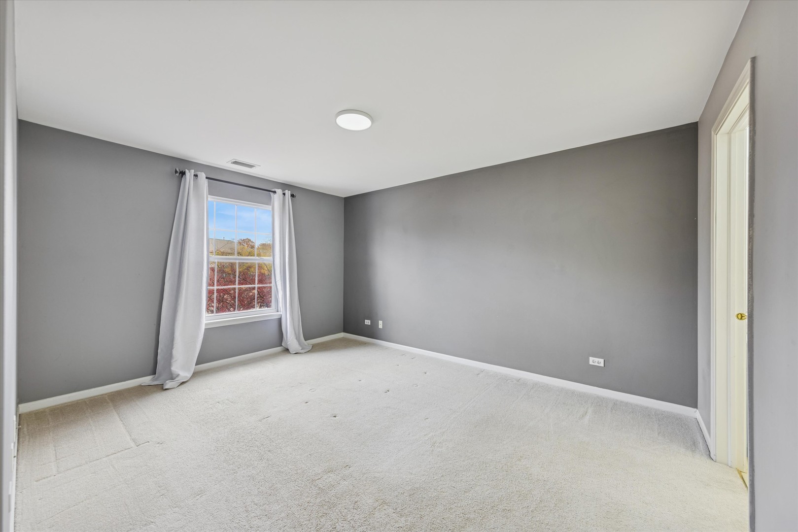 1101 Yorkshire Court, Unit C Elgin, IL 60120 - Photo 10 of 19 a view of an empty room with a window