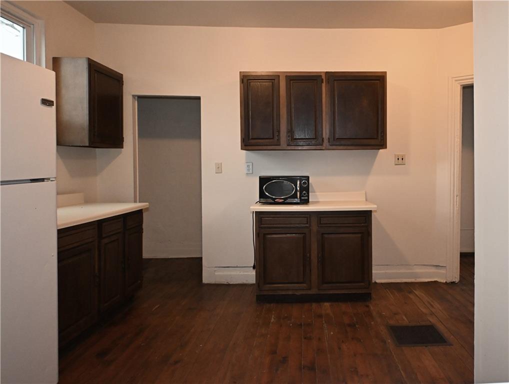 417 Lawn Street Pittsburgh, PA 15213 - Photo 13 of 26 a kitchen with stainless steel appliances granite countertop a refrigerator and a stove top oven