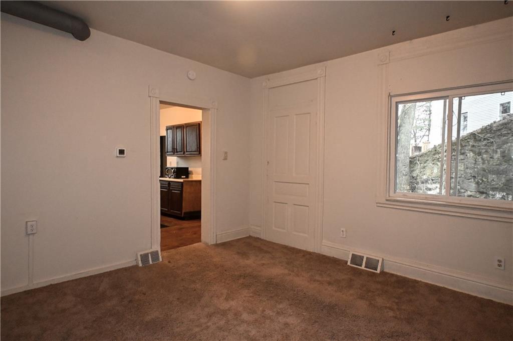 417 Lawn Street Pittsburgh, PA 15213 - Photo 15 of 26 an empty room with windows and closet