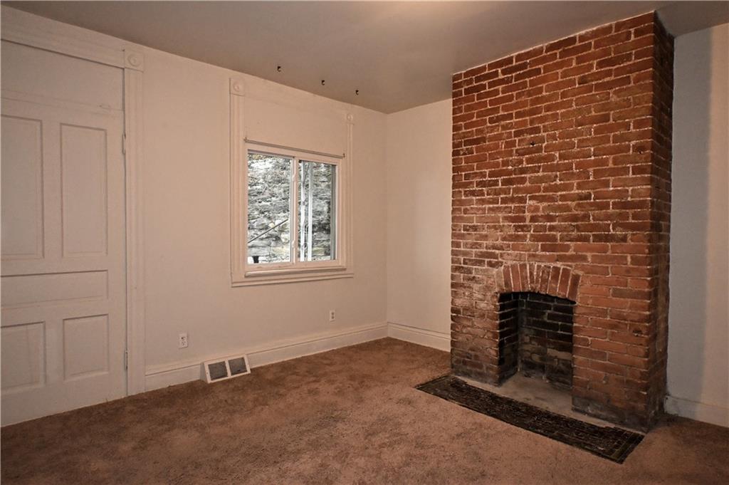 417 Lawn Street Pittsburgh, PA 15213 - Photo 16 of 26 a view of empty room with fireplace