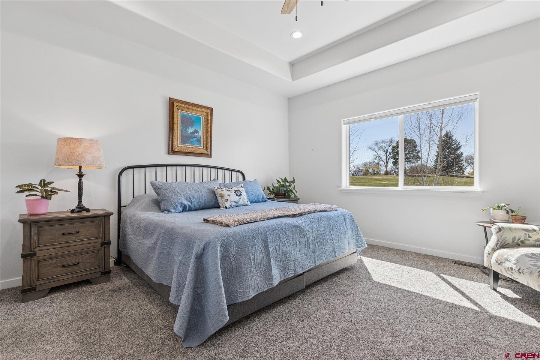 1937 Golf Course Lane Cortez, CO 81321 - Photo 18 of 31 a spacious bedroom with a bed and a painting on the wall