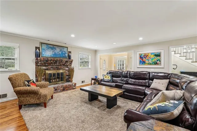 a living room with fireplace furniture and a flat screen tv