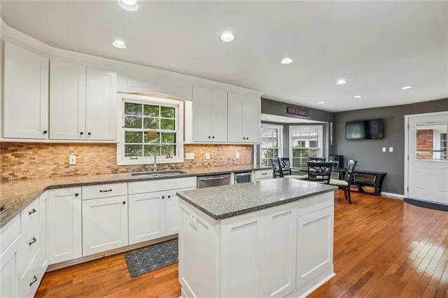 a kitchen with granite countertop a sink a counter top space and living room