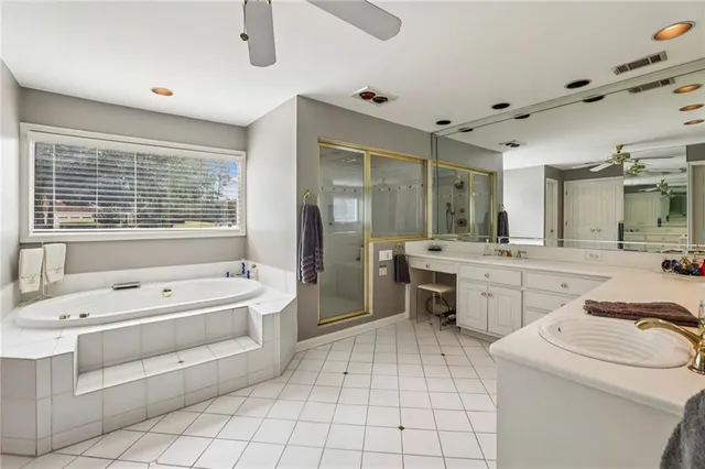 a bathroom with a sink mirror vanity and bathtub