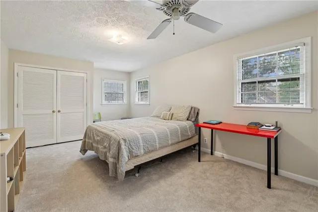 a spacious bedroom with a bed and a chandelier