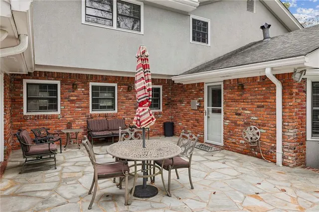 a backyard of a house with table and chairs