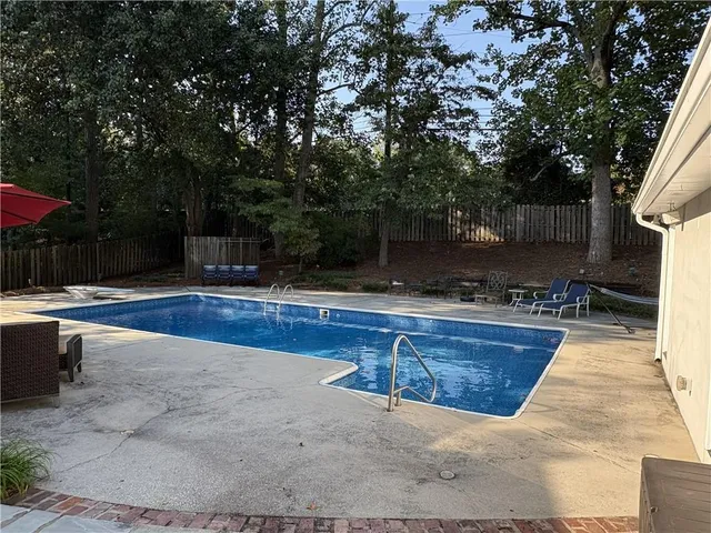 a swimming pool with outdoor seating