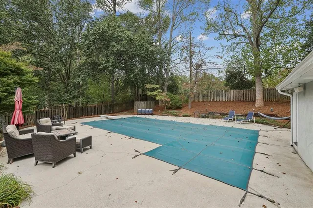 a view of backyard with a table and chairs