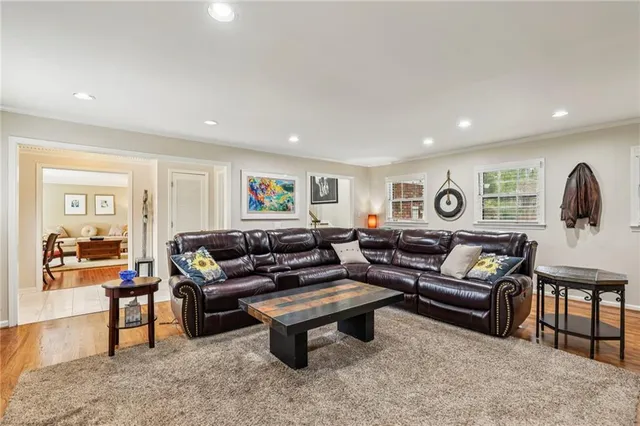 a living room with furniture and wooden floor