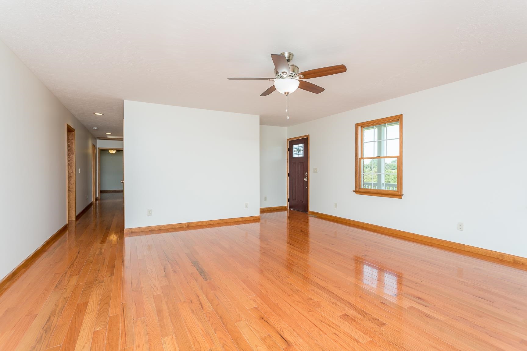297 Battlefield Road Waynesboro, VA 22980 - Photo 16 of 61 an empty room with wooden floor a ceiling fan and windows