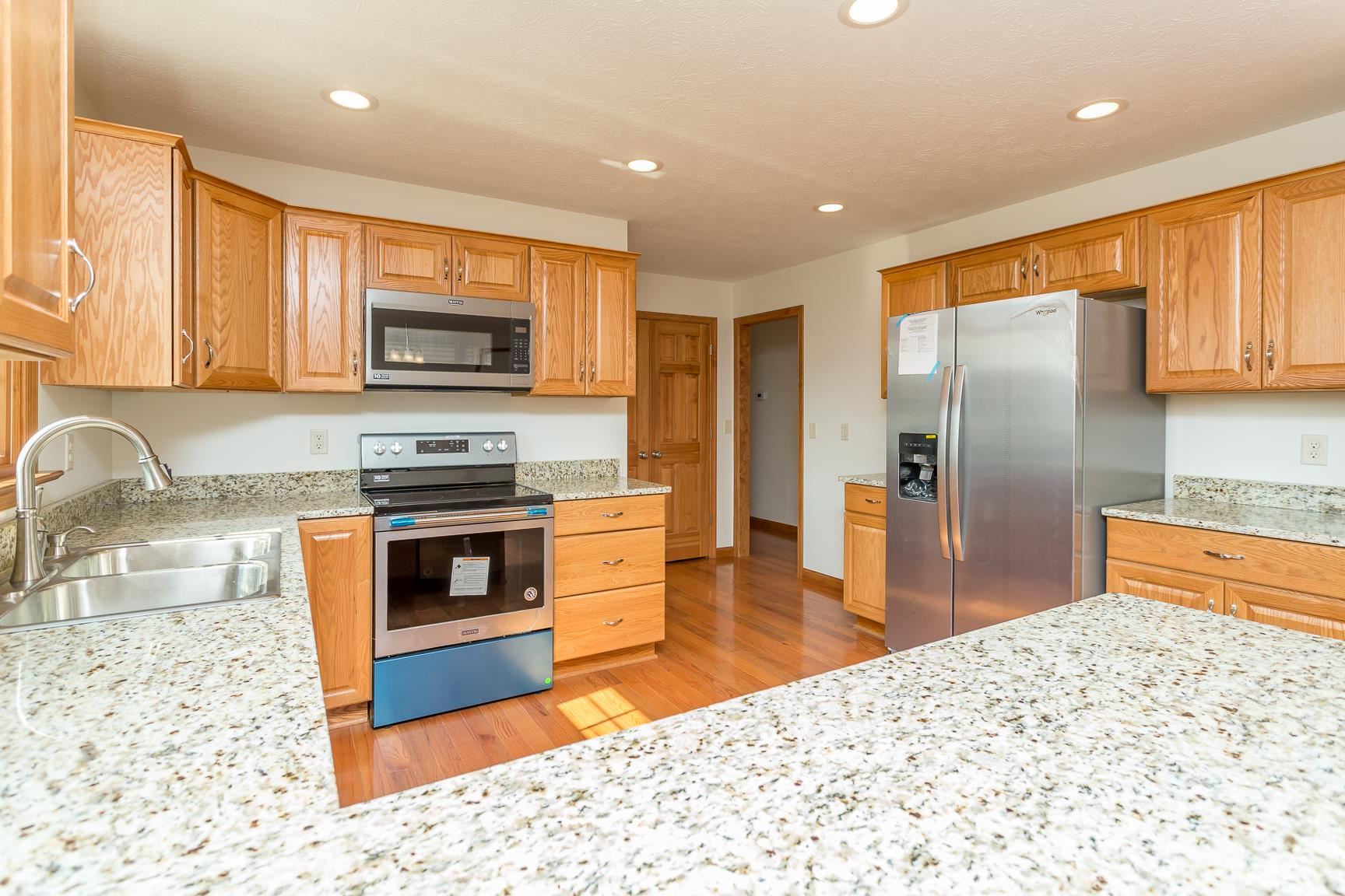 297 Battlefield Road Waynesboro, VA 22980 - Photo 2 of 61 a kitchen with stainless steel appliances kitchen island granite countertop a stove a sink and a microwave