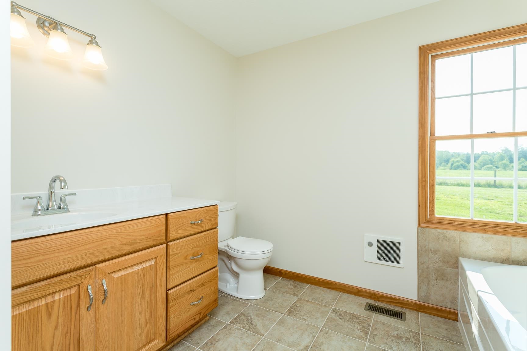 297 Battlefield Road Waynesboro, VA 22980 - Photo 28 of 61 a bathroom with a sink a toilet and a window