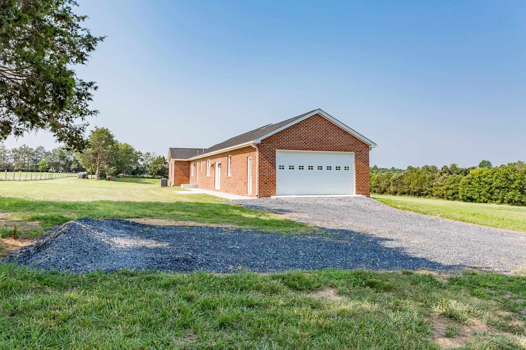 297 Battlefield Road Waynesboro, VA 22980 - Photo 50 of 61 a front view of a house with a yard and garage