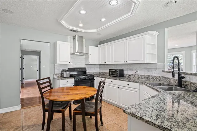 a kitchen with granite countertop kitchen island a table and chairs in it