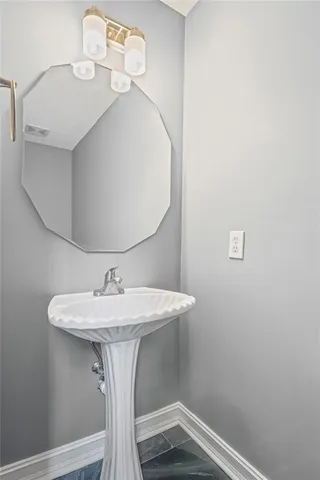 a bathroom with a sink and mirror