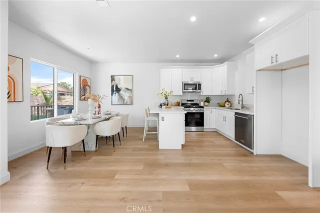 a kitchen with cabinets appliances a sink and a counter top space