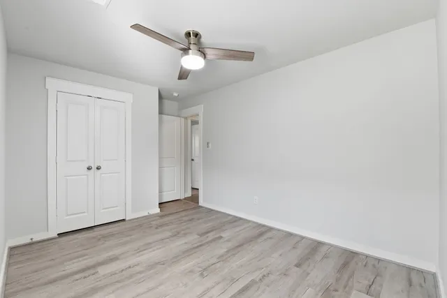 a view of an empty room with wooden floor