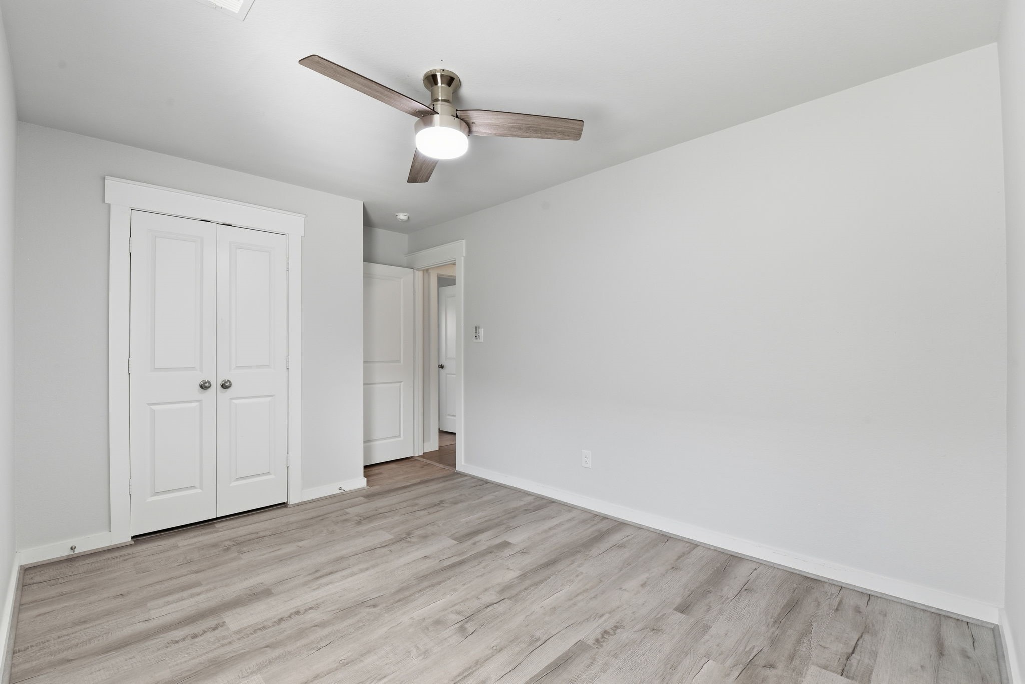 12411 Southern Trail Court Magnolia, TX 77354 - Photo 19 of 38 a view of an empty room with wooden floor