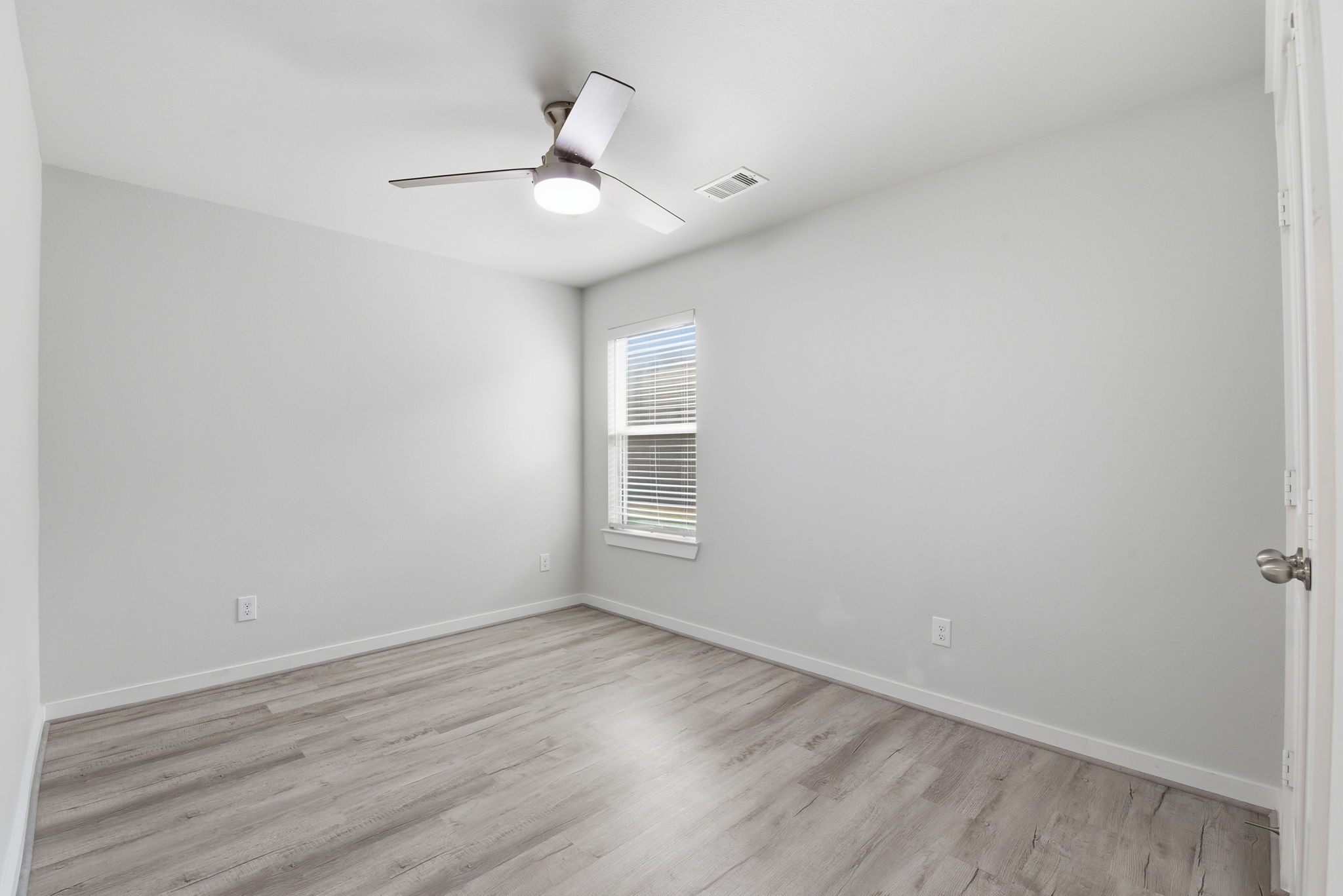 12411 Southern Trail Court Magnolia, TX 77354 - Photo 20 of 38 a view of an empty room with wooden floor and a ceiling fan