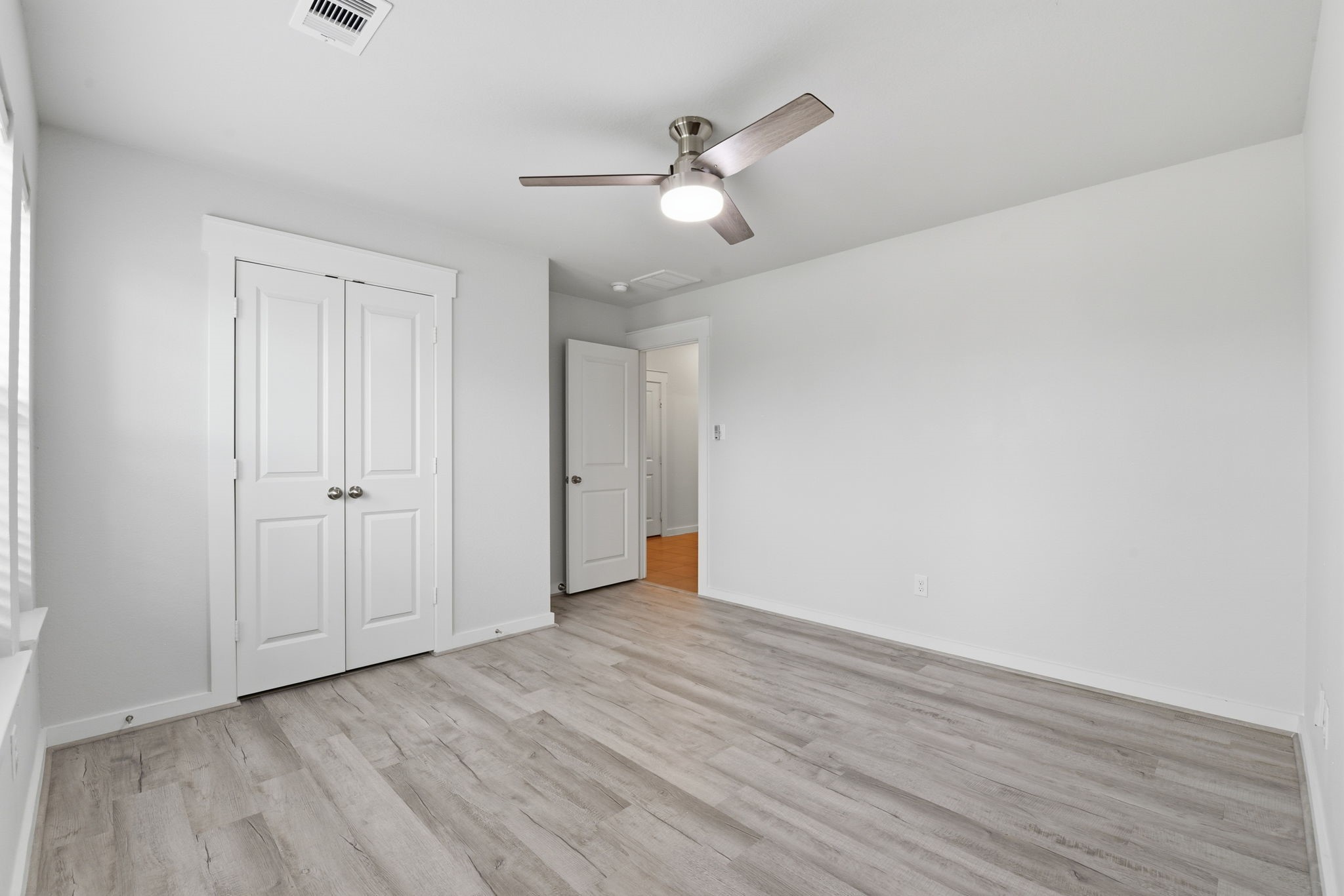 12411 Southern Trail Court Magnolia, TX 77354 - Photo 21 of 38 a view of an empty room with wooden floor